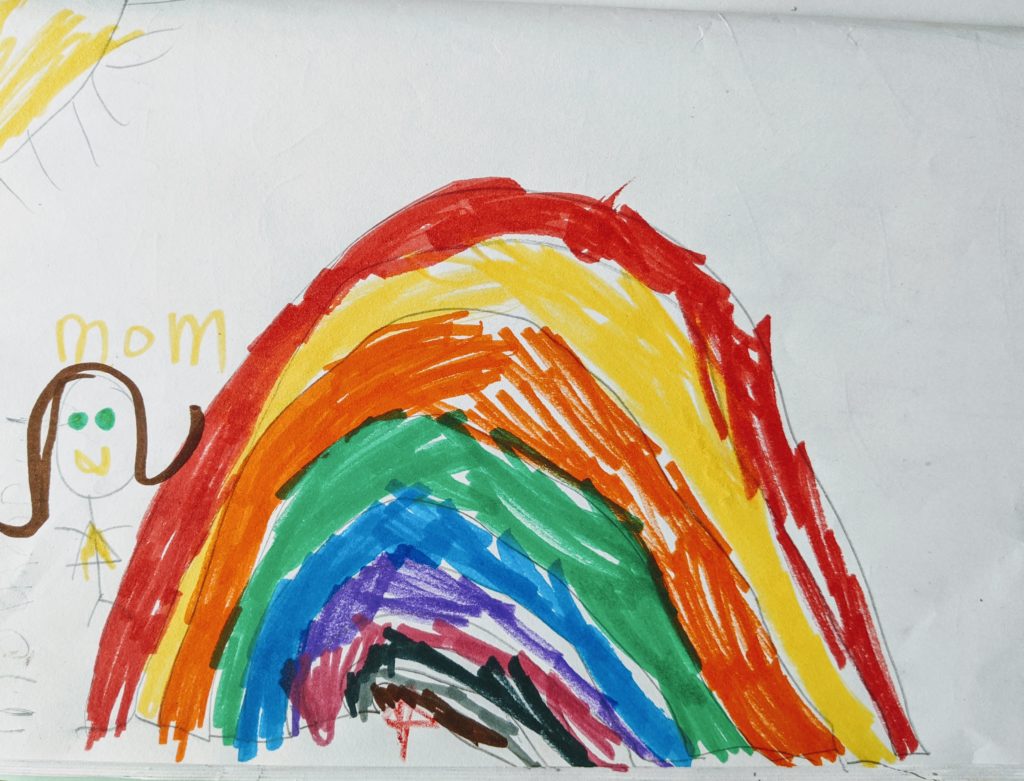 A drawing in marker of a rainbow, sun, and Hannah's mom.